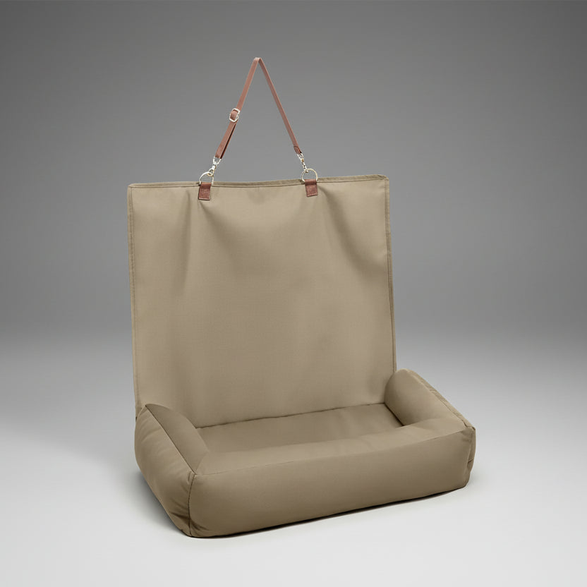 Beige hanging chair with brown straps on a white background